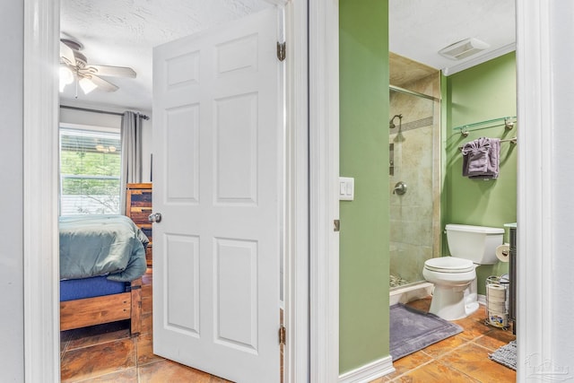 bathroom with ceiling fan, toilet, tile patterned flooring, walk in shower, and a textured ceiling