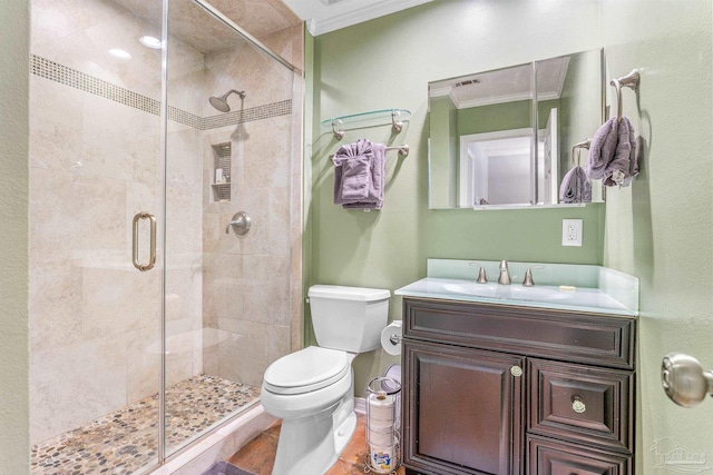 bathroom with tile patterned flooring, vanity, crown molding, toilet, and walk in shower