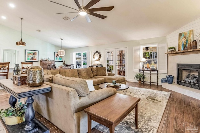 living room featuring vaulted ceiling, dark hardwood / wood-style floors, ceiling fan, and french doors