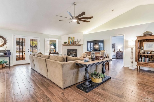 living room featuring hardwood / wood-style flooring, vaulted ceiling, ceiling fan, and french doors