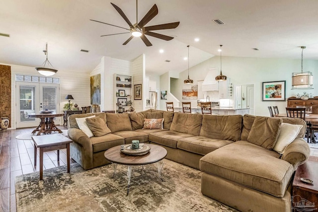 living room featuring french doors, wood-type flooring, and high vaulted ceiling