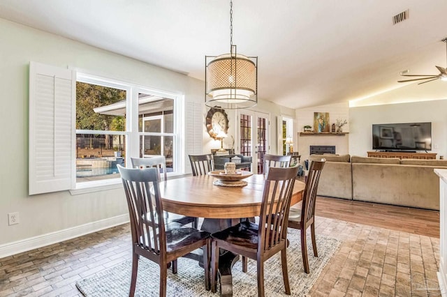 dining area with vaulted ceiling, a healthy amount of sunlight, and ceiling fan