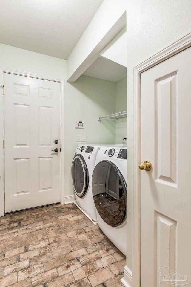 washroom with washing machine and clothes dryer