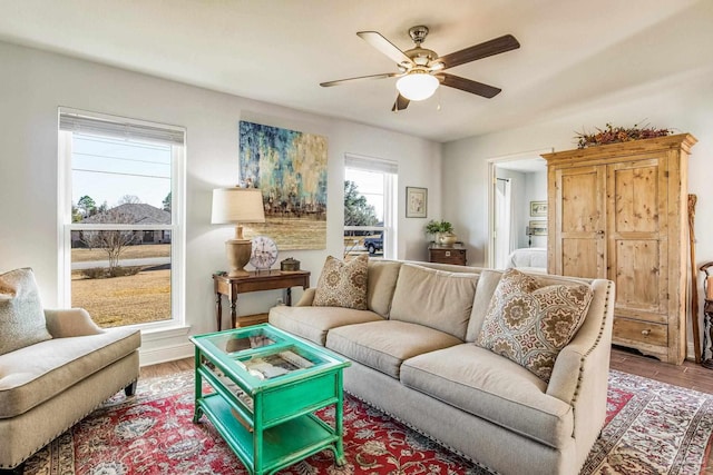 living room featuring hardwood / wood-style floors and ceiling fan