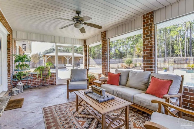 sunroom / solarium featuring ceiling fan