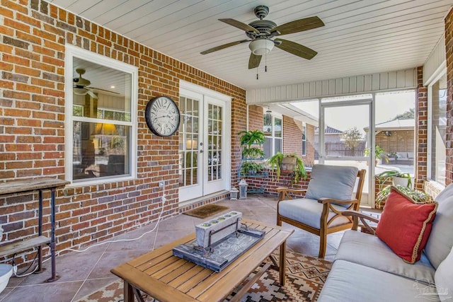 sunroom / solarium featuring french doors, ceiling fan, and wooden ceiling