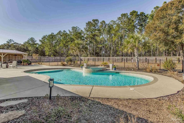 view of pool with an in ground hot tub, a gazebo, and a patio area