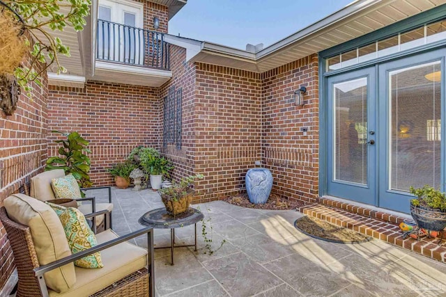 view of patio featuring french doors and a balcony