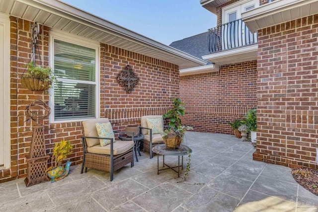 view of patio featuring a balcony