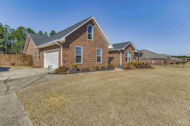 view of front of property featuring a garage and a front lawn