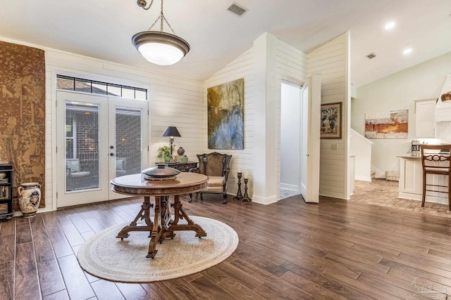 interior space featuring lofted ceiling, a wealth of natural light, dark wood-type flooring, and french doors