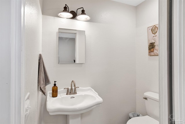 bathroom featuring sink and toilet