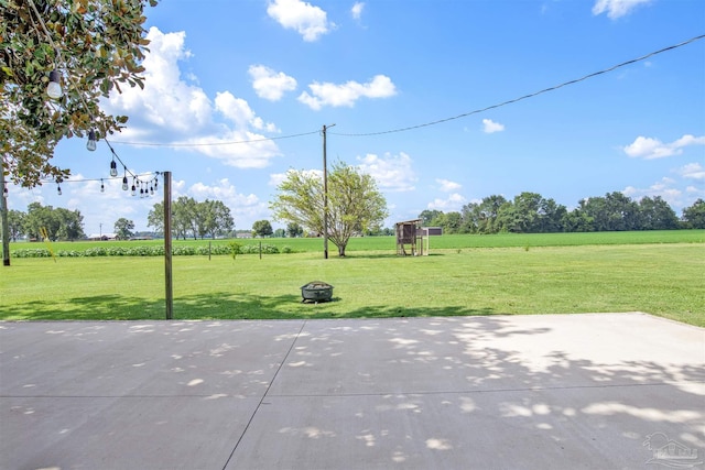 view of patio / terrace featuring a rural view and an outdoor fire pit