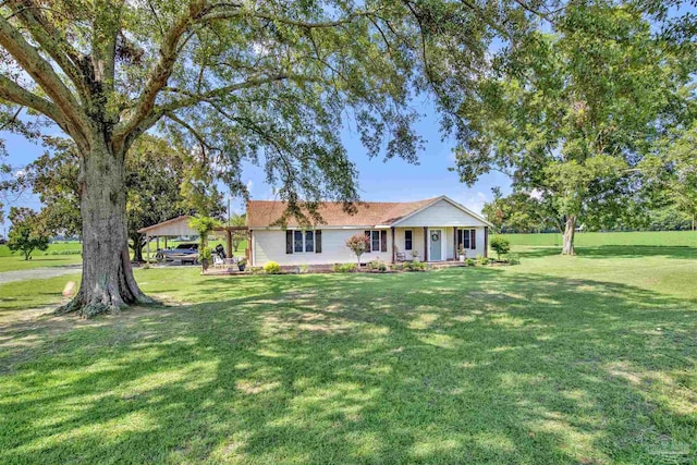 ranch-style home featuring covered porch and a front lawn