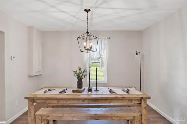 dining room featuring dark hardwood / wood-style floors and a chandelier