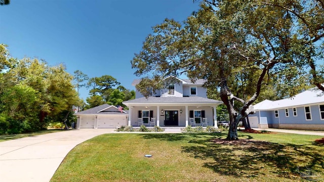 view of front of house with a front yard, a garage, and a porch