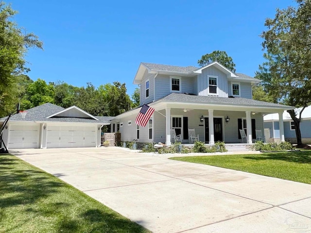 view of front of house featuring a porch, a garage, and a front yard