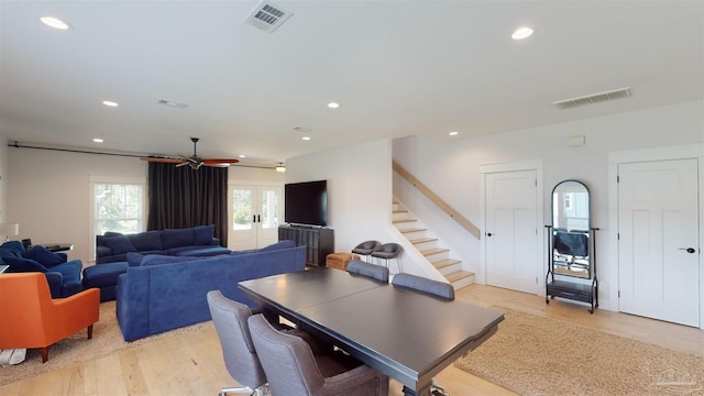 dining space featuring light hardwood / wood-style floors, ceiling fan, and french doors