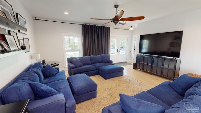 living room with french doors, ceiling fan, light hardwood / wood-style floors, and a healthy amount of sunlight