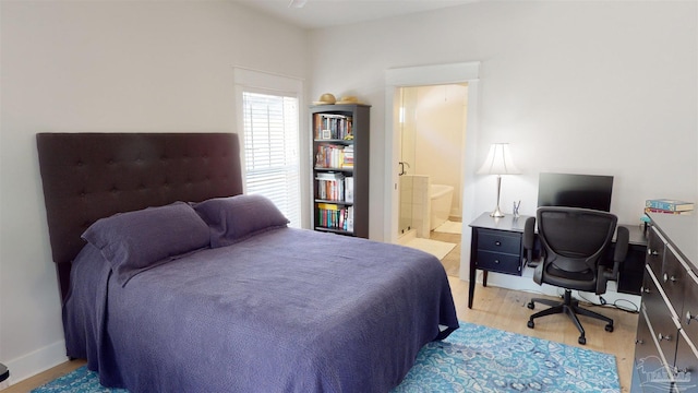 bedroom featuring light hardwood / wood-style floors and ensuite bathroom