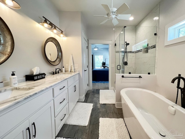 bathroom featuring vanity, hardwood / wood-style floors, ceiling fan, and plus walk in shower