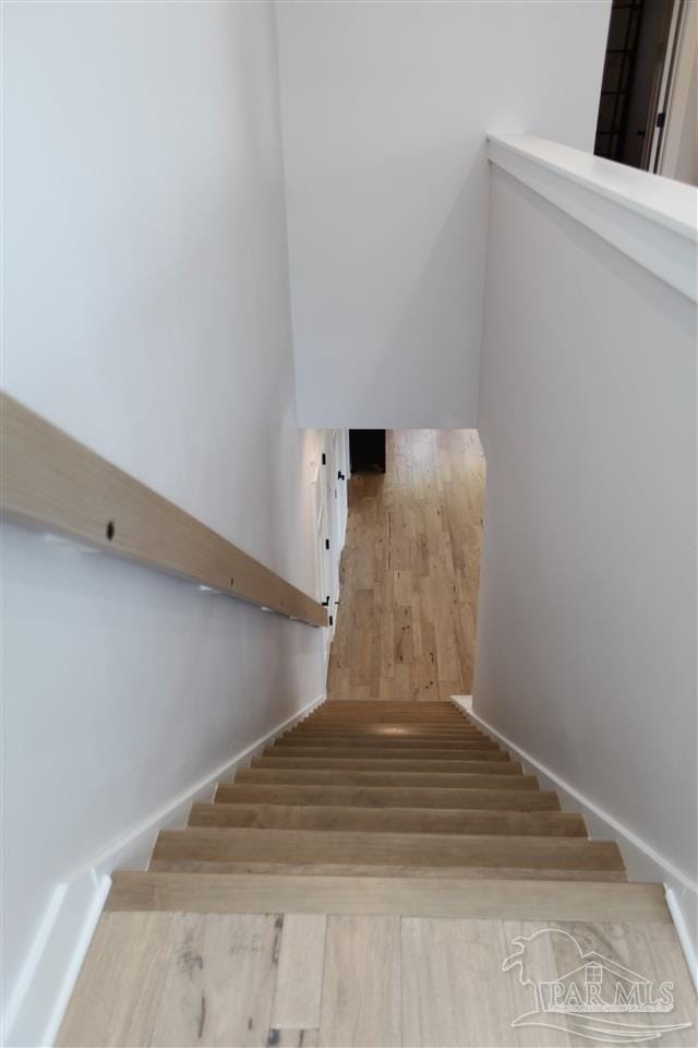 stairs with hardwood / wood-style flooring