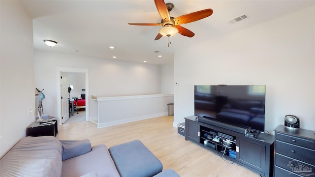 living room featuring light wood-type flooring and ceiling fan