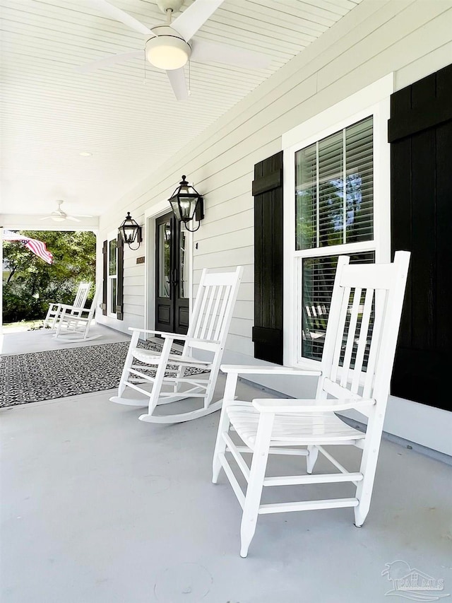 view of patio with ceiling fan and a porch