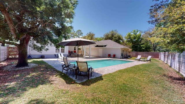 view of pool with a lawn and a patio area