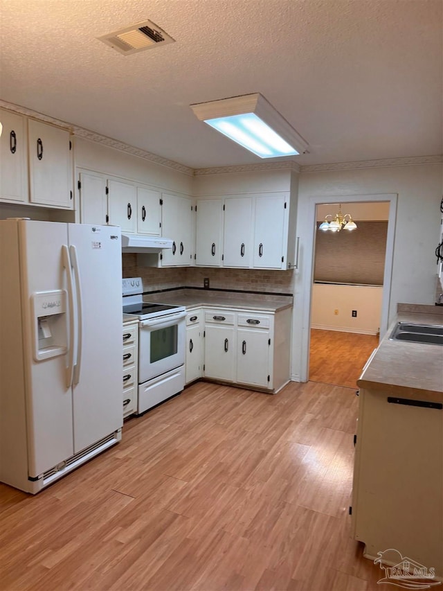 kitchen featuring light hardwood / wood-style flooring, hanging light fixtures, white appliances, and white cabinetry