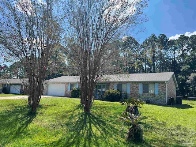 ranch-style home with a garage and a front lawn