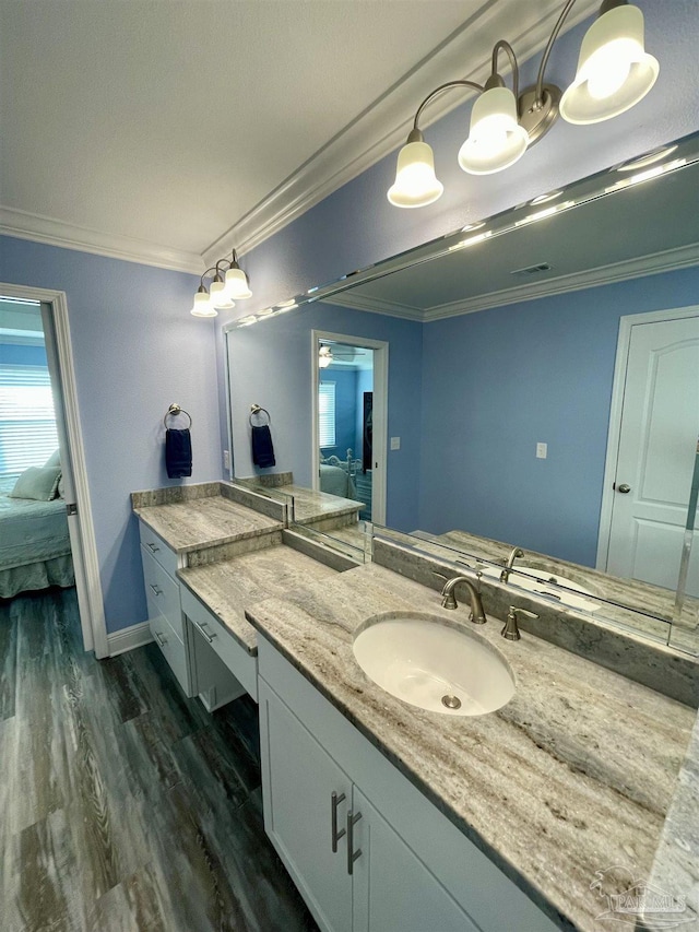 bathroom with vanity, wood-type flooring, and crown molding