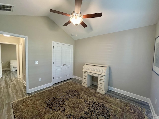 bedroom with ceiling fan, a closet, dark hardwood / wood-style flooring, and vaulted ceiling