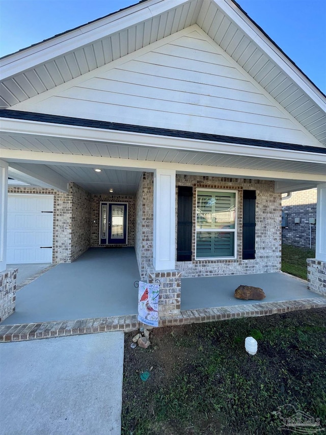 view of front of property featuring a garage and a porch