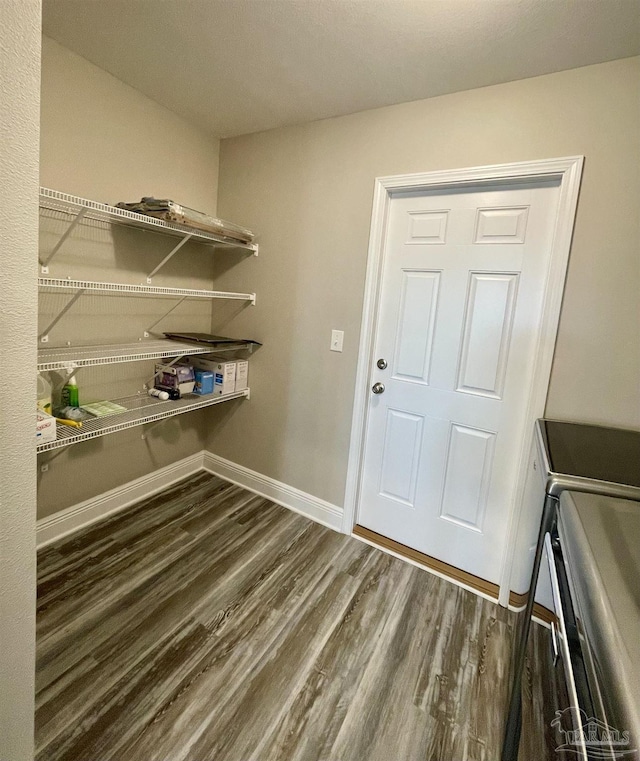 clothes washing area featuring washing machine and clothes dryer and dark hardwood / wood-style flooring