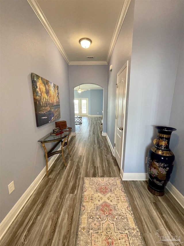 corridor with crown molding and dark wood-type flooring