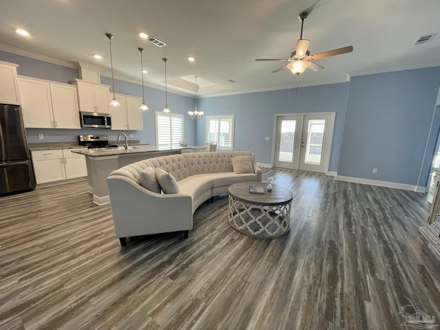 living room featuring french doors, ceiling fan with notable chandelier, dark hardwood / wood-style floors, and sink