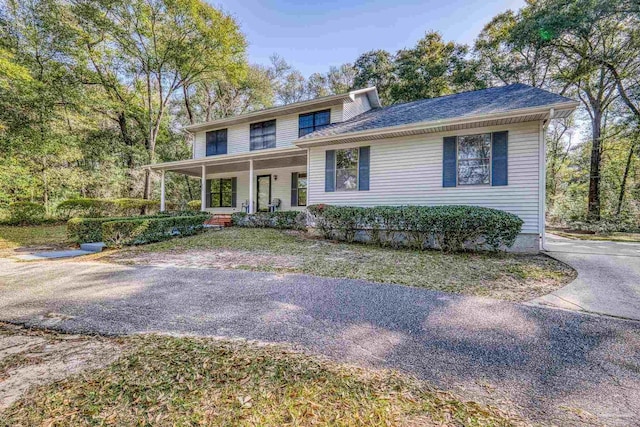 view of front of home with a porch and roof with shingles