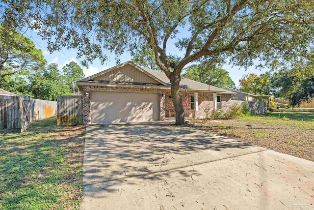 ranch-style house featuring a front yard and a garage