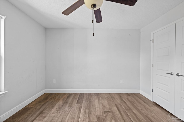 unfurnished room featuring ceiling fan, a textured ceiling, and hardwood / wood-style flooring