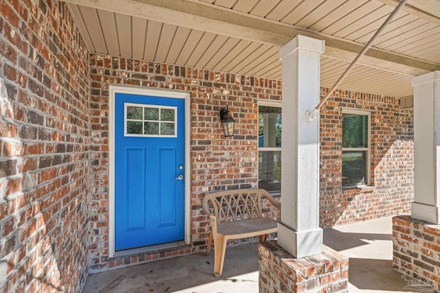 view of exterior entry featuring a porch