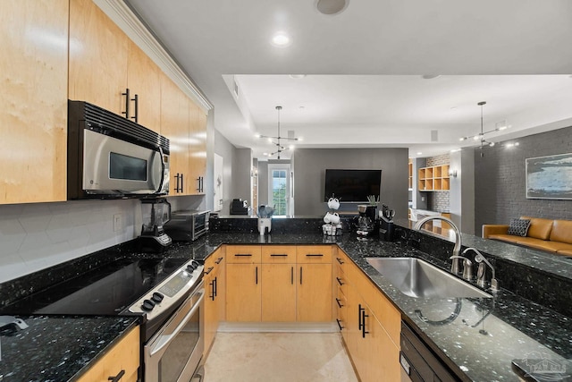 kitchen with pendant lighting, sink, dark stone countertops, a chandelier, and stainless steel appliances