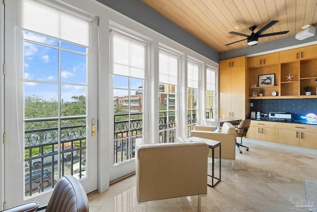 interior space with wood ceiling and ceiling fan