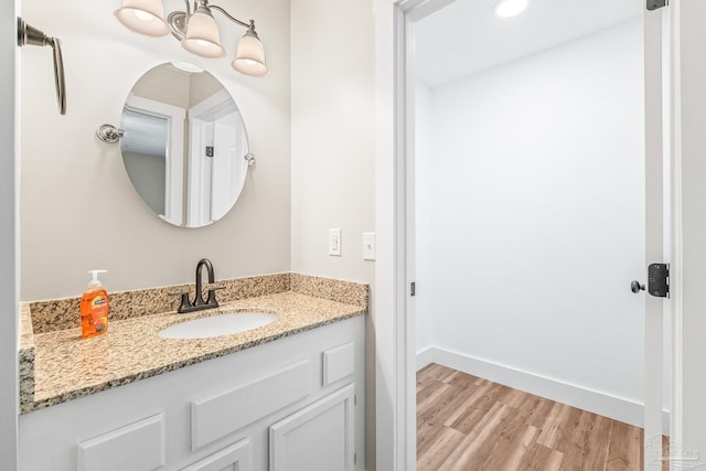 bathroom with hardwood / wood-style floors and vanity