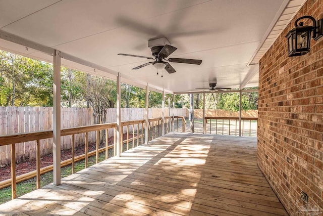 wooden terrace featuring ceiling fan