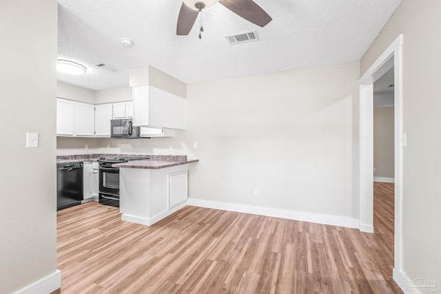 kitchen featuring kitchen peninsula, ceiling fan, black appliances, light hardwood / wood-style floors, and white cabinetry