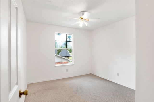 carpeted spare room with ceiling fan and a textured ceiling