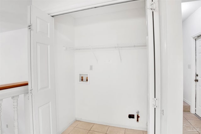 washroom with hookup for a washing machine and light tile patterned floors