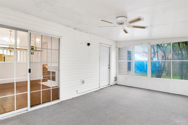 unfurnished sunroom featuring ceiling fan