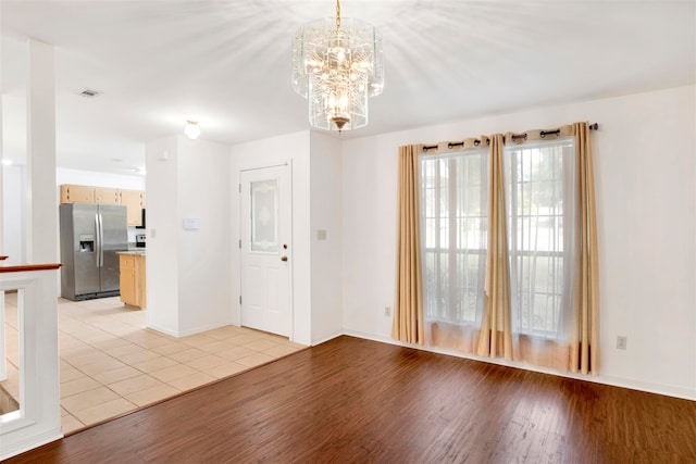 entryway featuring a notable chandelier and light wood-type flooring